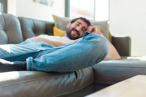 Young Bearded Man Resting Couch His Smartphone — Stock Photo, Image