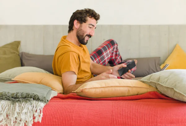 Junger Bärtiger Mann Auf Einem Bett Mit Seinem Handy — Stockfoto