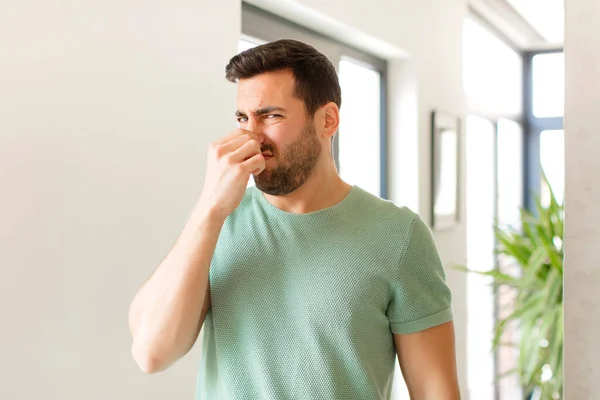 Handsome Man Feeling Disgusted Holding Nose Avoid Smelling Foul Unpleasant — Stock Photo, Image