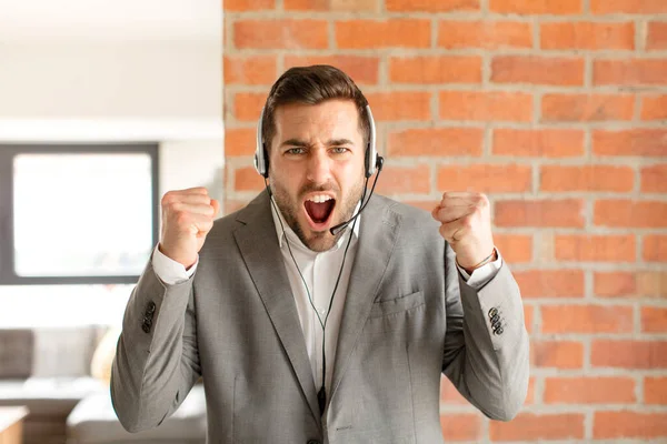 Handsome Telemarketer Shouting Aggressively Angry Expression Fists Clenched Celebrating Success — Stock Photo, Image