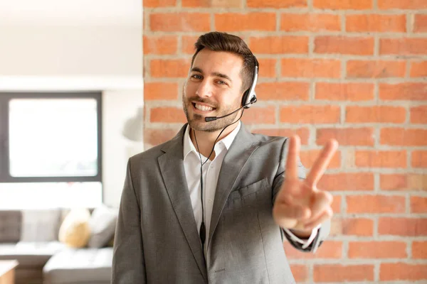Handsome Telemarketer Smiling Looking Happy Carefree Positive Gesturing Victory Peace — Stock Photo, Image