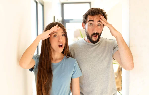 Jovem Casal Olhando Feliz Surpreso Surpreso Sorrindo Percebendo Incrível Incrível — Fotografia de Stock