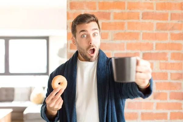 若いハンサムな男が家でコーヒーを飲んでいて — ストック写真