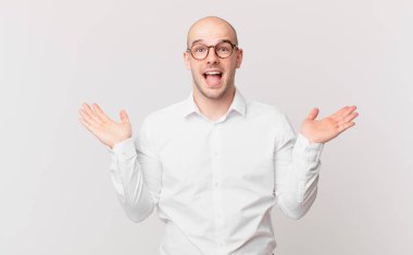 Kel adam mutlu, heyecanlı, şaşırmış ya da şok olmuş hissediyor, gülümsüyor ve inanılmaz bir şeye şaşırıyor.