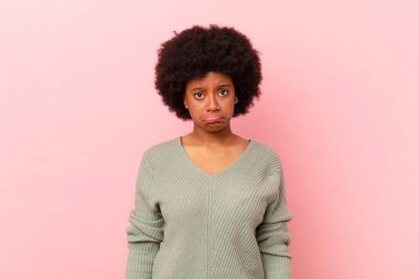 Afro siyah kadın üzgün ve mızmız, mutsuz bir bakışla ağlıyor, olumsuz ve hayal kırıklığına uğramış bir tavırla.