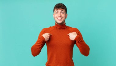 Yakışıklı adam mutlu, şaşkın ve gururlu, heyecanlı, şaşkın bakışlarla kendini işaret ediyor.