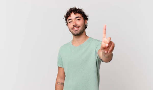 Hispanic Handsome Man Smiling Looking Friendly Showing Number One First — Stock Photo, Image