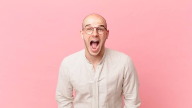 Kel adam agresif bir şekilde bağırıyor, çok kızgın, sinirli, öfkeli ya da sinirli görünüyor, hayır