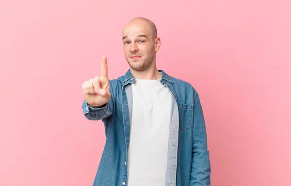 Bald Man Smiling Proudly Confidently Making Number One Pose Triumphantly — Stock Photo, Image