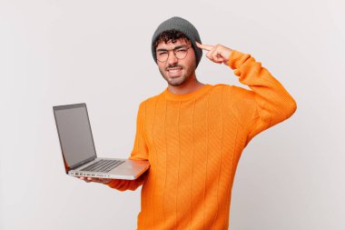 nerd man with computer feeling confused and puzzled, showing you are insane, crazy or out of your mind