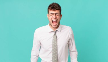 Genç işadamı agresif bir şekilde bağırıyor, sinirli, sinirli, öfkeli ya da sinirli görünüyor, hayır diyor.