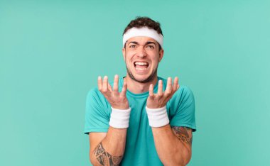 Fitness adamı umutsuz ve sinirli görünüyor, stresli, mutsuz ve sinirli, bağırıyor ve çığlık atıyor.