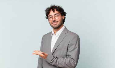 İspanyol işadamı mutlu bir şekilde gülümsüyor, mutlu hissediyor ve fotokopi dünyasında avucuyla bir konsept gösteriyor.