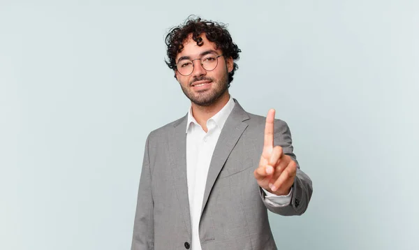 Hombre Negocios Hispano Sonriendo Mirando Amistoso Mostrando Número Uno Primero —  Fotos de Stock