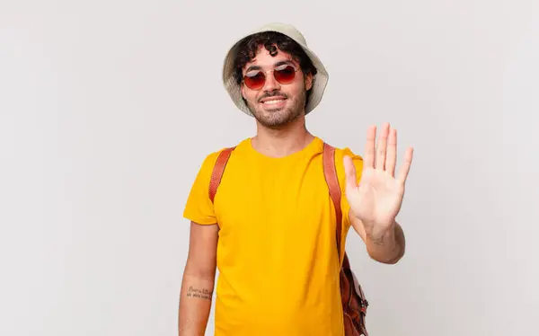 Hispanic Tourist Man Smiling Happily Cheerfully Waving Hand Welcoming Greeting — Stock Photo, Image