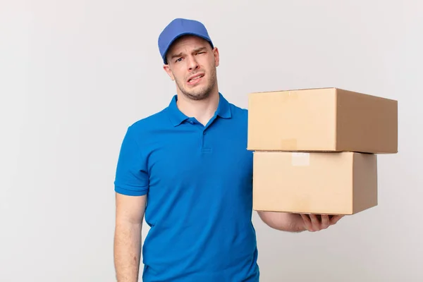 Package Deliver Man Feeling Puzzled Confused Dumb Stunned Expression Looking — Stok fotoğraf