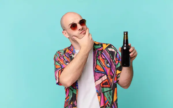 tourist with beer tourist man thinking, feeling doubtful and confused, with different options, wondering which decision to make