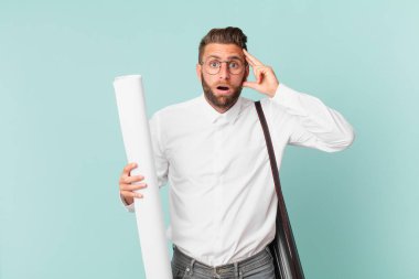 Genç yakışıklı adam şaşırmış görünüyor, yeni bir düşünce, fikir ya da konsept fark ediyor. mimar konsepti