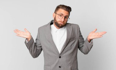 Genç yakışıklı adam şaşkın, şaşkın ve şüpheci hissediyor. iş kavramı