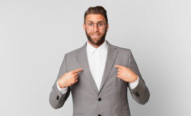 young handsome man feeling happy and pointing to self with an excited. business concept