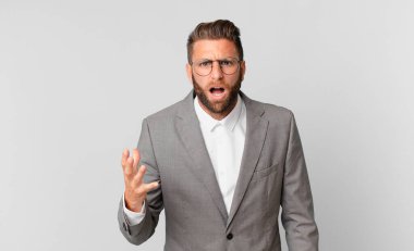 young handsome man looking angry, annoyed and frustrated. business concept