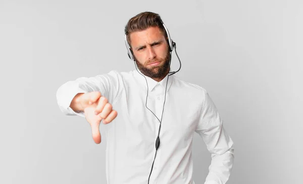 Joven Hombre Guapo Sintiendo Cruz Mostrando Los Pulgares Hacia Abajo —  Fotos de Stock