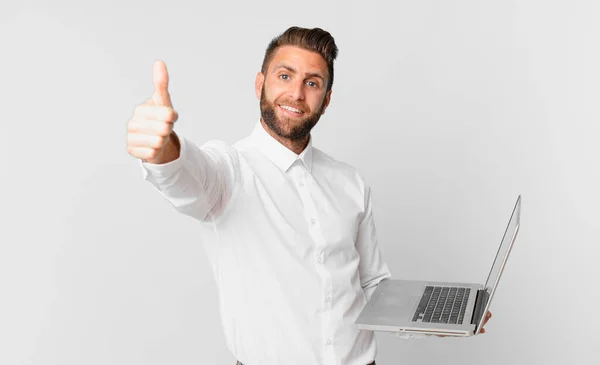 Young Handsome Man Feeling Proud Smiling Positively Thumbs Holding Laptop — Φωτογραφία Αρχείου