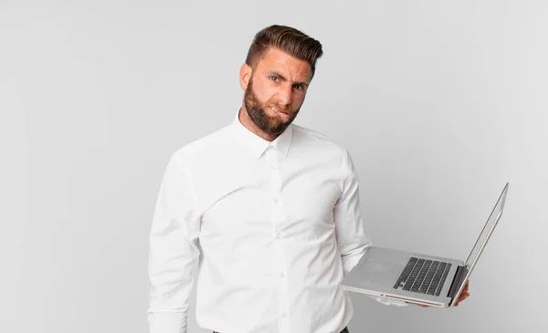 Young Handsome Man Looking Puzzled Confused Holding Laptop — Φωτογραφία Αρχείου