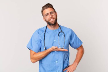 young handsome man smiling cheerfully, feeling happy and showing a concept. nurse concept