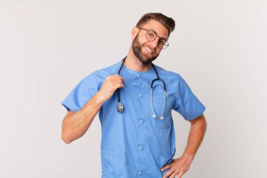 young handsome man looking arrogant, successful, positive and proud. nurse concept