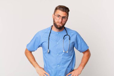 young handsome man looking puzzled and confused. nurse concept