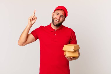 young handsome man feeling like a happy and excited genius after realizing an idea burger delivering concept