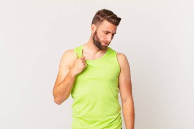 Genç ve yakışıklı adam stresli, endişeli, yorgun ve hayal kırıklığına uğramış hissediyor. fitness konsepti