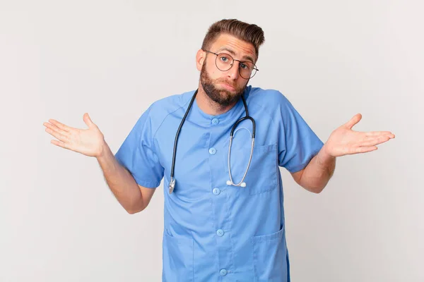 Young Handsome Man Feeling Puzzled Confused Doubting Nurse Concept — Stok fotoğraf