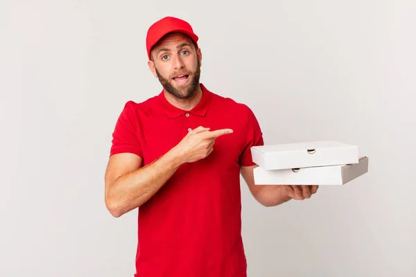 Young Handsome Man Looking Excited Surprised Pointing Side Pizza Delivering — Stock Photo, Image