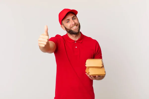 Young Handsome Man Feeling Proud Smiling Positively Thumbs Burger Delivering — Foto de Stock