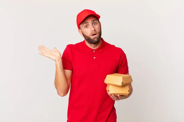 Young Handsome Man Looking Surprised Shocked Jaw Dropped Holding Object — Stock Photo, Image