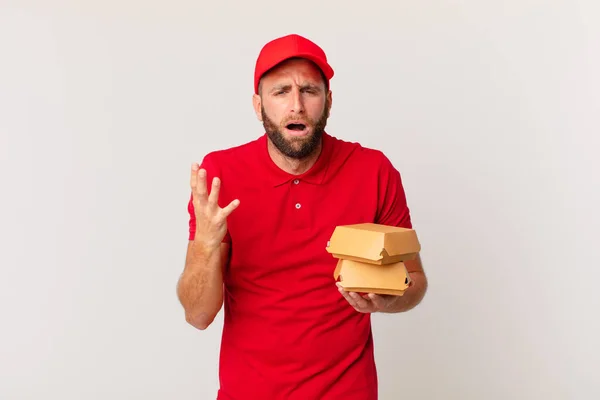 Young Handsome Man Looking Desperate Frustrated Stressed Burger Delivering Concept — Stok fotoğraf