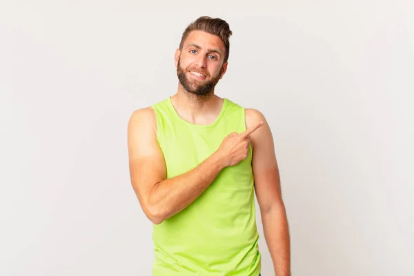Young Handsome Man Smiling Cheerfully Feeling Happy Pointing Side Fitness — Stockfoto