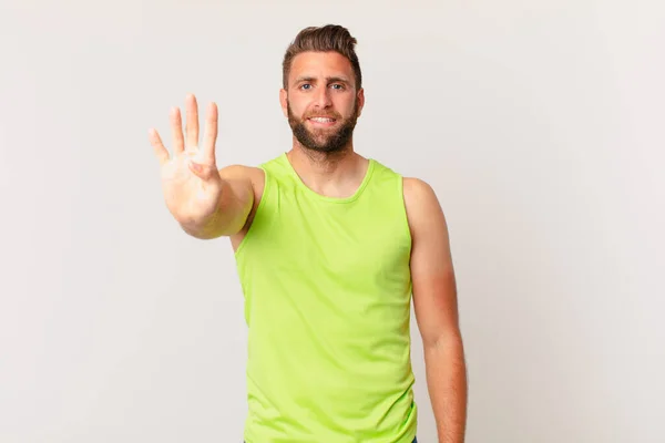 Young Handsome Man Smiling Looking Friendly Showing Number Four Fitness — Foto Stock