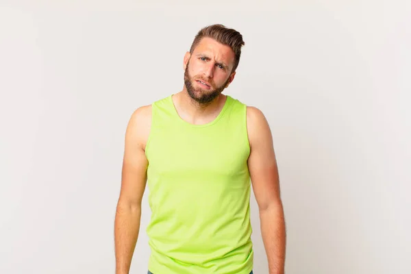 Young Handsome Man Feeling Puzzled Confused Fitness Concept — Stock Photo, Image