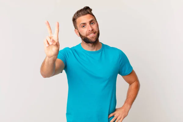 Young Handsome Man Smiling Looking Happy Gesturing Victory Peace Fitness — Stockfoto