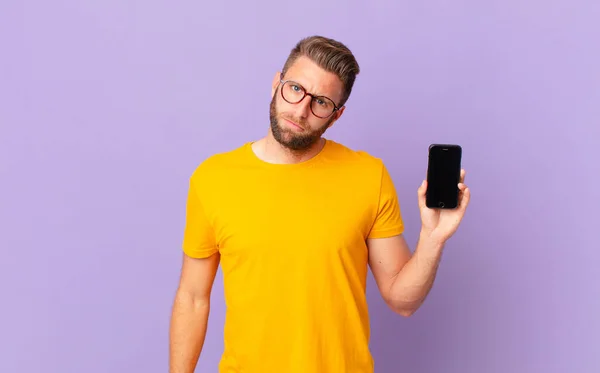 Young Handsome Man Feeling Puzzled Confused Cell Concept — Stockfoto