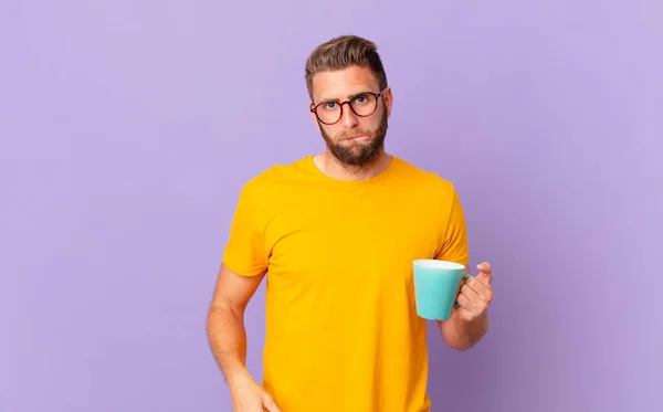 Young Handsome Man Looking Puzzled Confused Holding Coffee Mug — Φωτογραφία Αρχείου