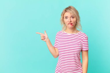 young pretty woman looking puzzled and confused. copy space concept