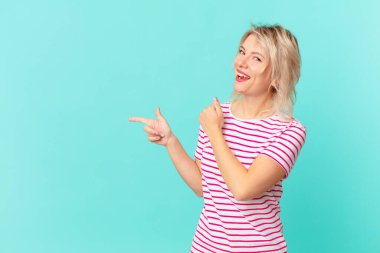 young pretty woman feeling happy and facing a challenge or celebrating. copy space concept