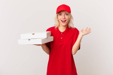 young pretty woman feeling happy and astonished at something unbelievable. pizza delivering concept