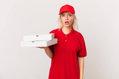 young pretty woman looking very shocked or surprised. pizza delivering concept