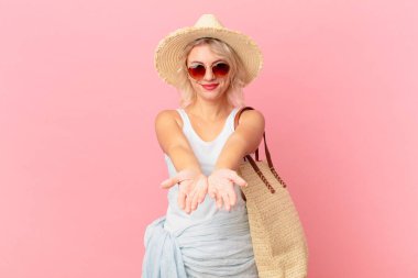 young pretty woman smiling happily with friendly and  offering and showing a concept. summer tourist concept