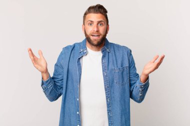 Genç yakışıklı adam kendini mutlu hissediyor ve inanılmaz bir şey karşısında şaşkına dönüyor.